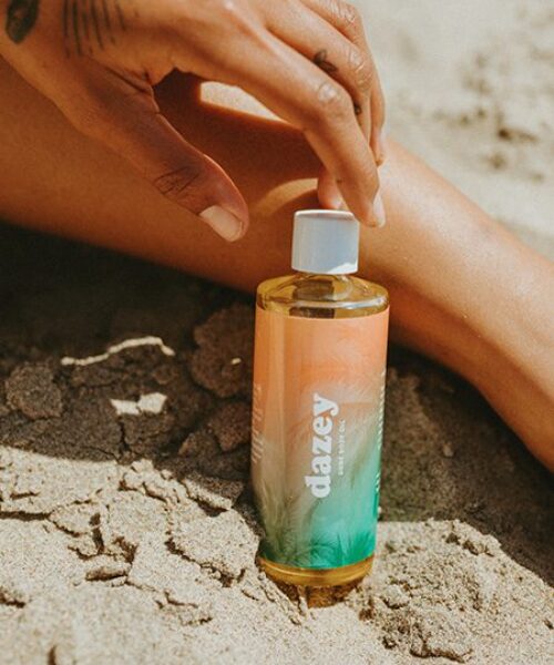 dune body oil on the beach